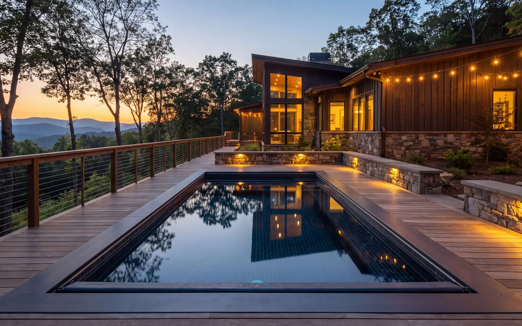 Pool set into a timber deck with landscape lighting at dusk