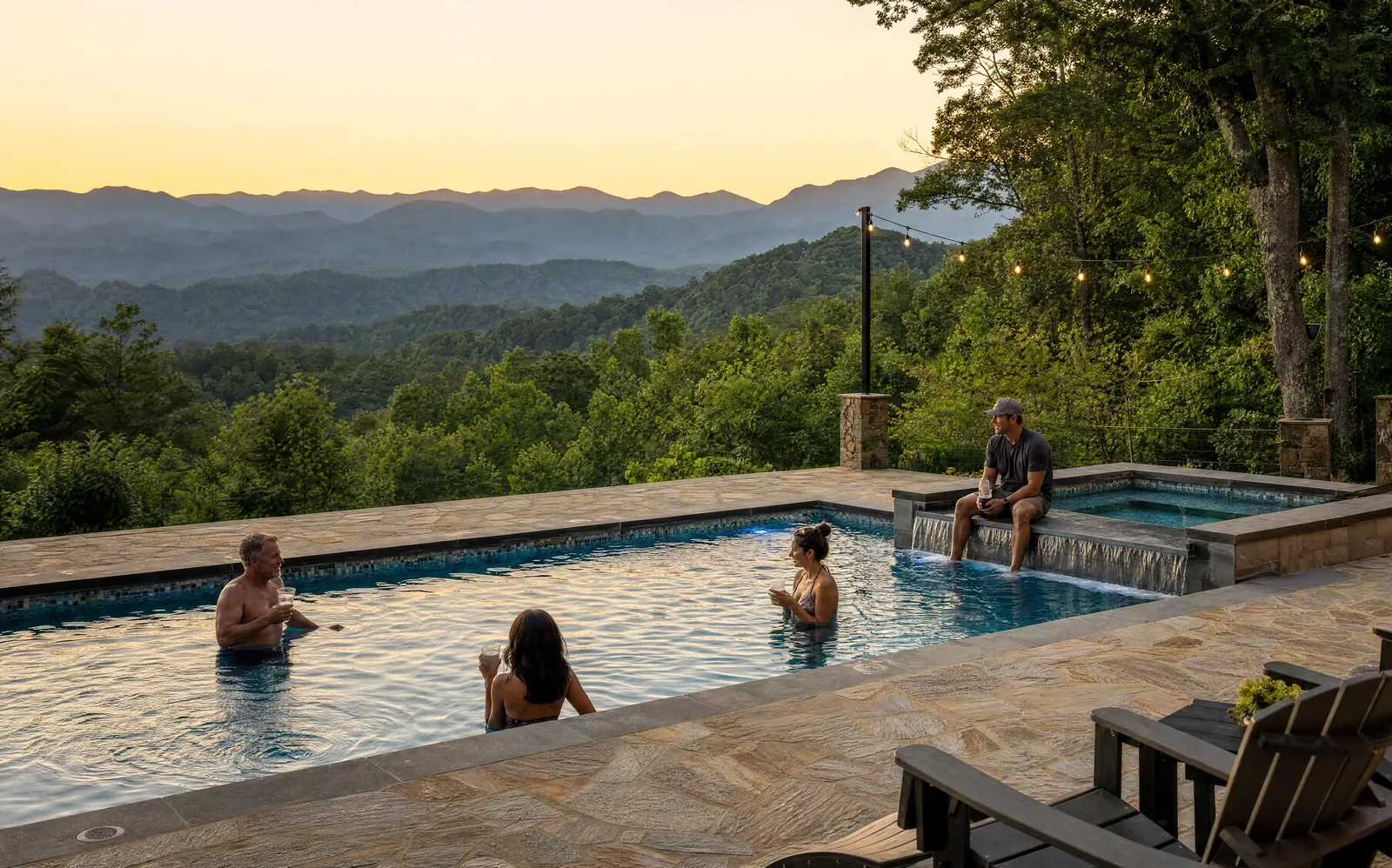 Friends in a pool at sunset beside a spillover spa