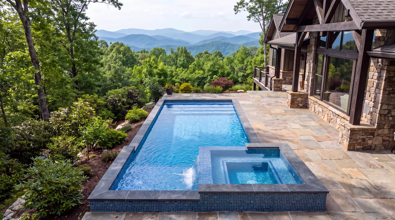Pool with a spillover spa on a flagstone patio