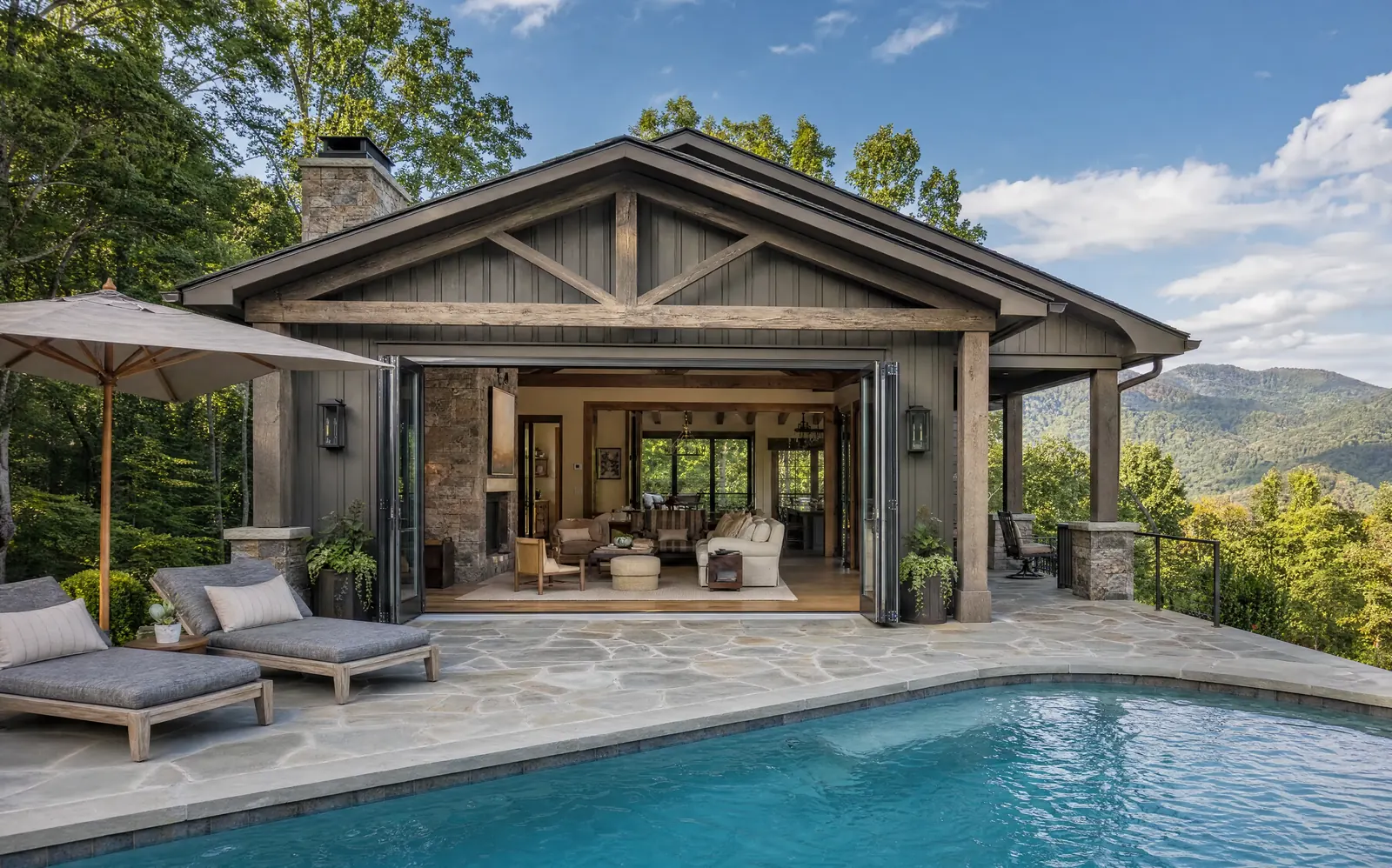 Pool house with folding doors open to the deck