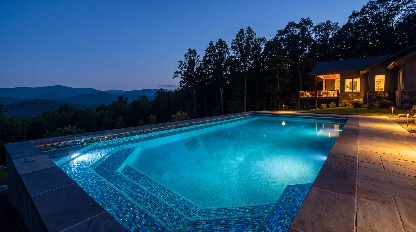 Pool lit at dusk with glass mosaic tile