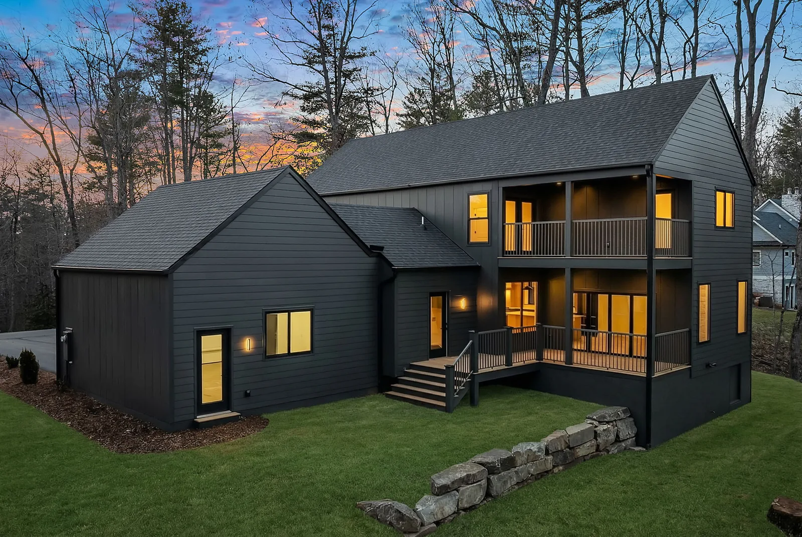 A stone retaining wall and graded lawn on a home we built